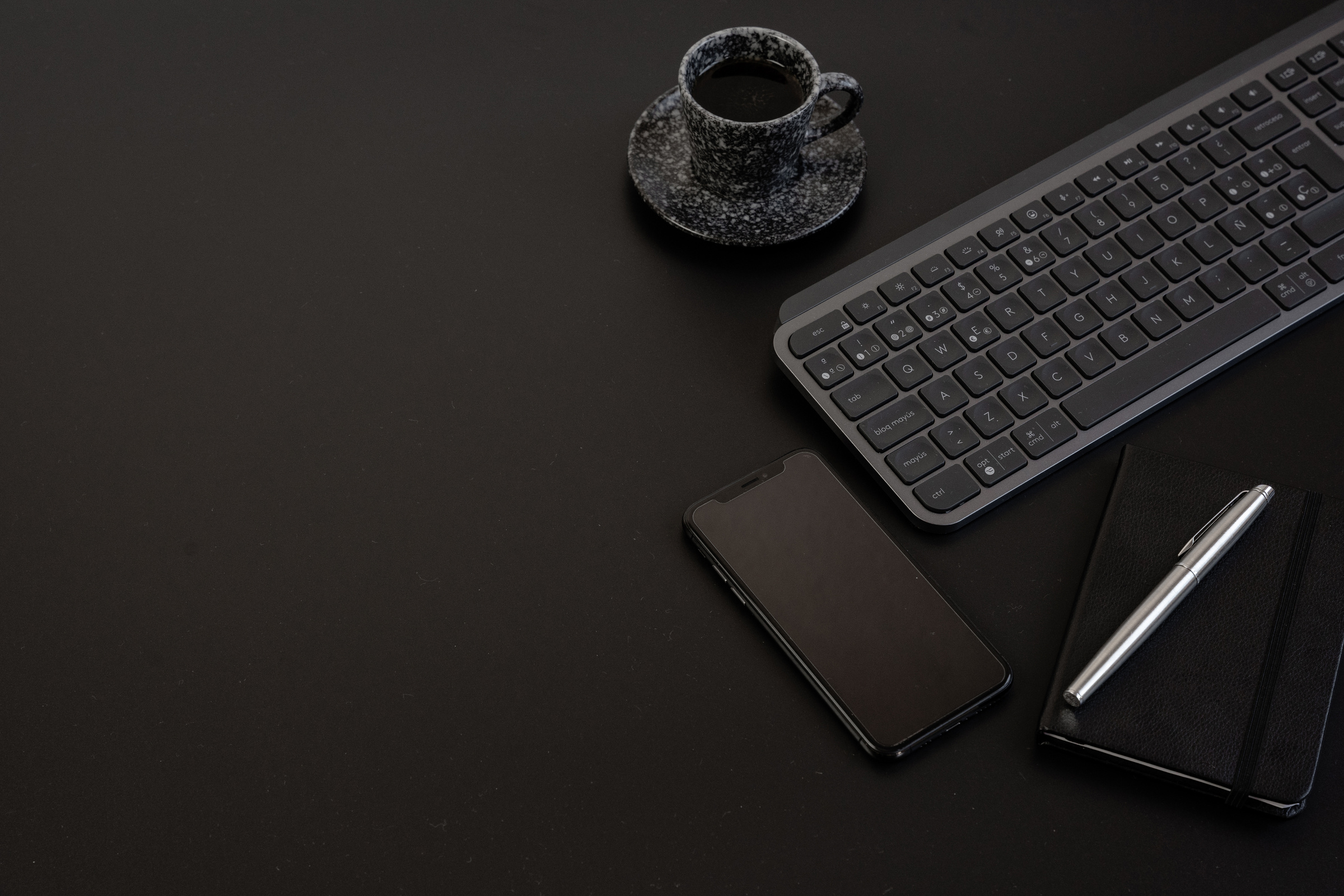 Phone, Computer Accessories and Coffee on Black Background
